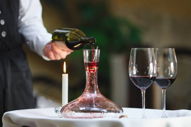 istock A sommelier pouring red wine into decanter 1270736643