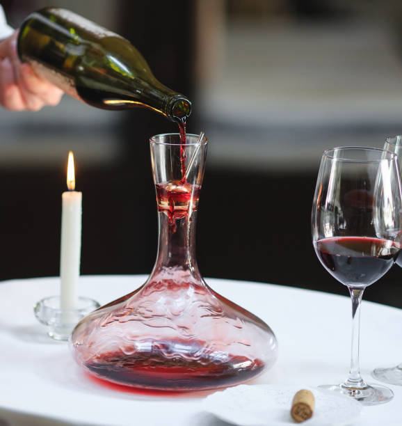 istock A sommelier pouring red wine into decanter 1270736645