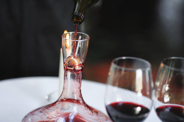 istock A sommelier pouring red wine into decanter 1270736658