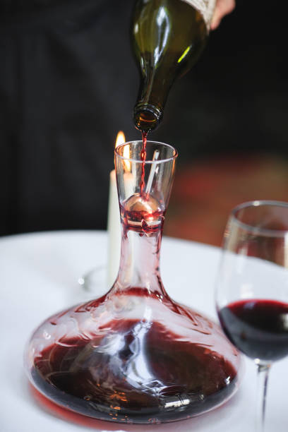istock A sommelier pouring red wine into decanter 1270736665