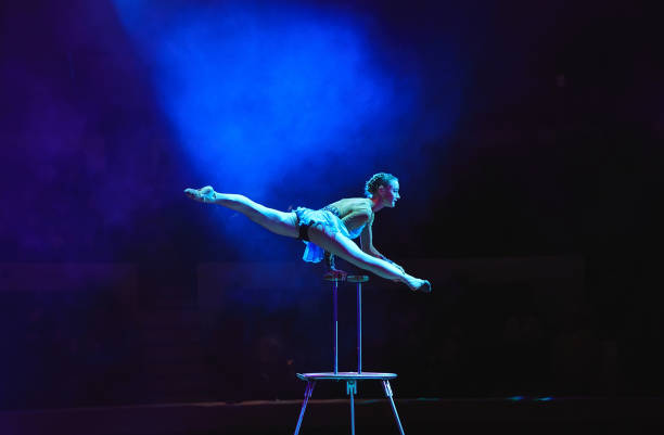 istock Aerial acrobat in the ring. A young girl performs the acrobatic elements in the air ring 1270736724