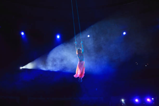 istock Aerial acrobat in the ring. A young girl performs the acrobatic elements in the air ring. 1270736751