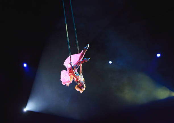 istock Aerial acrobat in the ring. A young girl performs the acrobatic elements in the air ring. 1270736754