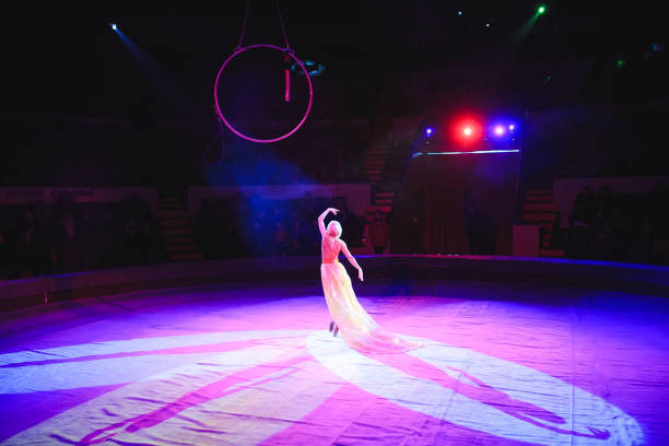 istock Aerial acrobat in the ring. A young girl performs the acrobatic elements in the air ring 1270736843