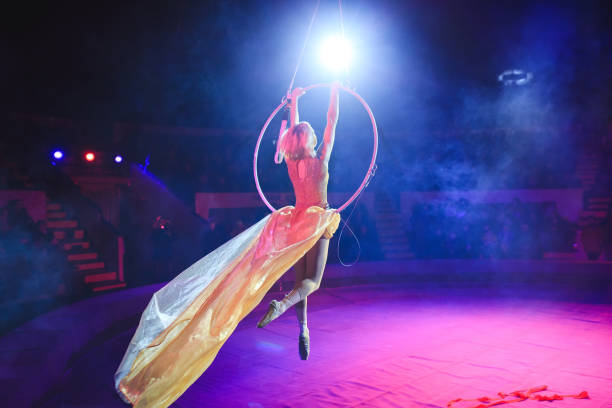istock Aerial acrobat in the ring. A young girl performs the acrobatic elements in the air ring 1270736848