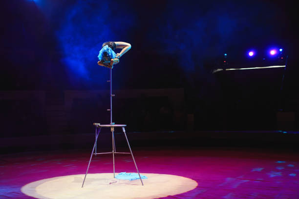 istock Aerial acrobat in the ring. A young girl performs the acrobatic elements in the air ring. 1270736867