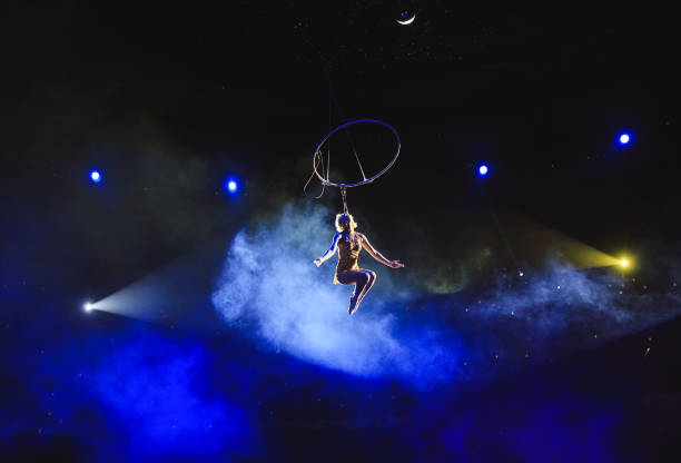 istock Aerial acrobat in the ring. A young girl performs the acrobatic elements in the air ring 1270736890