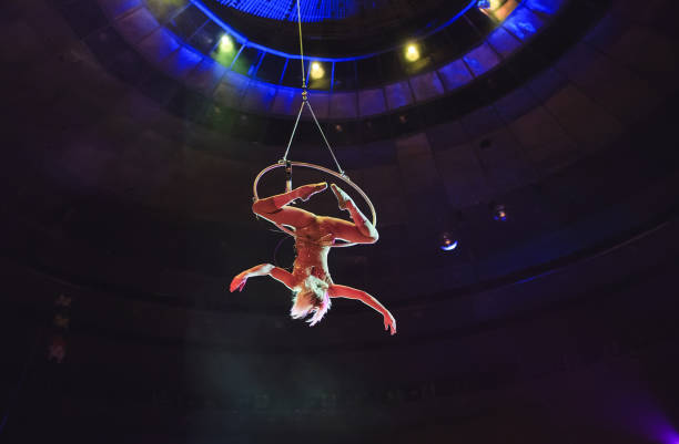 istock Aerial acrobat in the ring. A young girl performs the acrobatic elements in the air ring. 1270737429