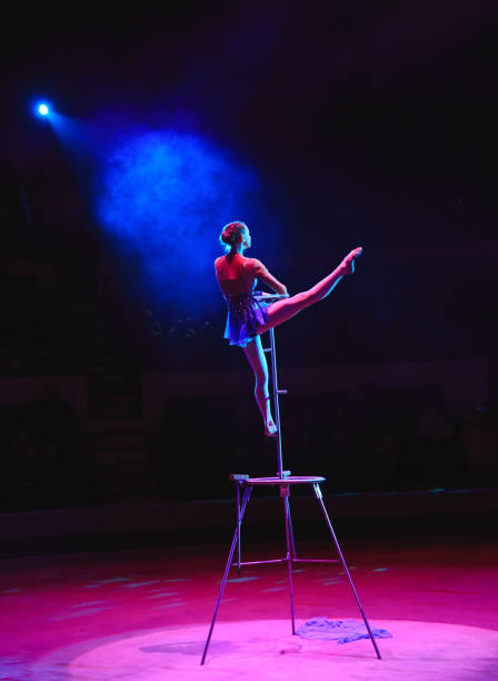 istock Aerial acrobat in the ring. A young girl performs the acrobatic elements in the air ring 1270737511