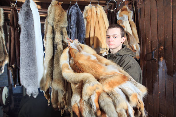 istock A young man hangs up the fur after treatment. 1270737559