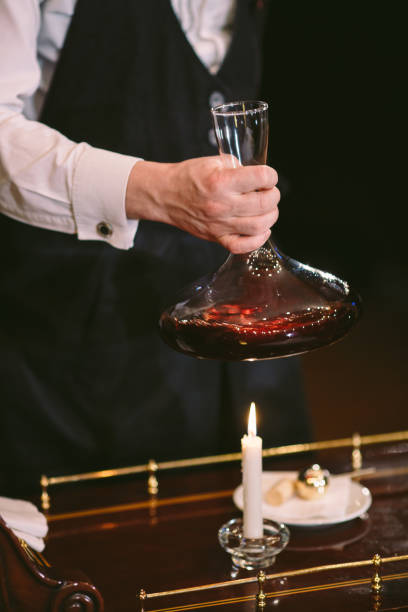 istock A sommelier pouring red wine into decanter 1270737756