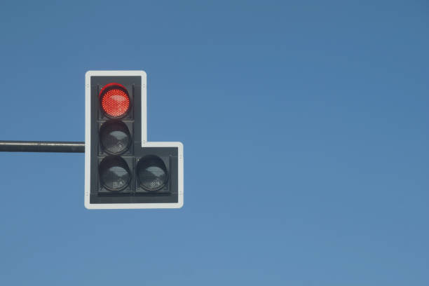 istock Red Traffic Light against Clear Blue Sky Background 1270741968