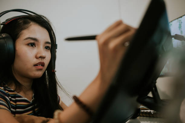 Gamer and animator designer with moment of thinking-stock photo The passion of young Asian creative designer  is drawing her upcoming ideas at her living room, Bangkok Thailand animator stock pictures, royalty-free photos & images