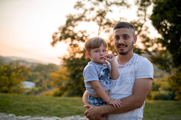 istock Dad holding his little son in his arms 1270742130