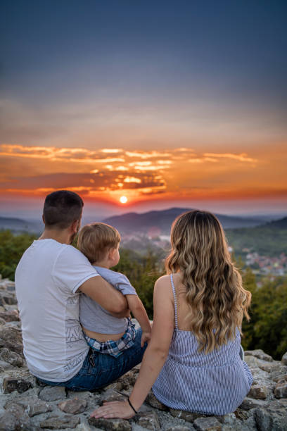 istock Young parents watching sunset with their little son 1270742920