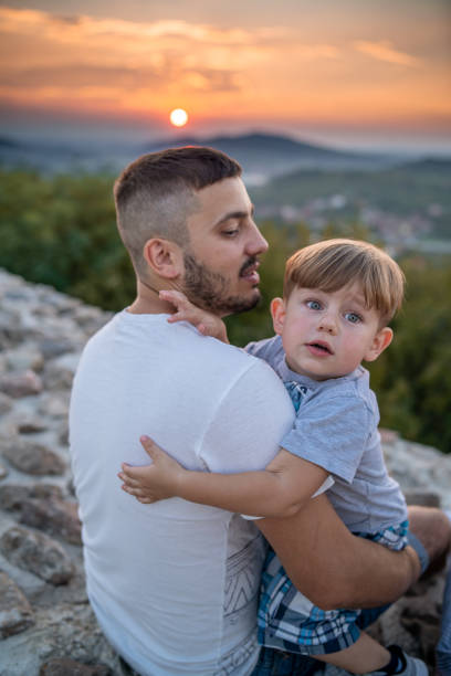 istock Little child sitting in his dad's lap 1270743117