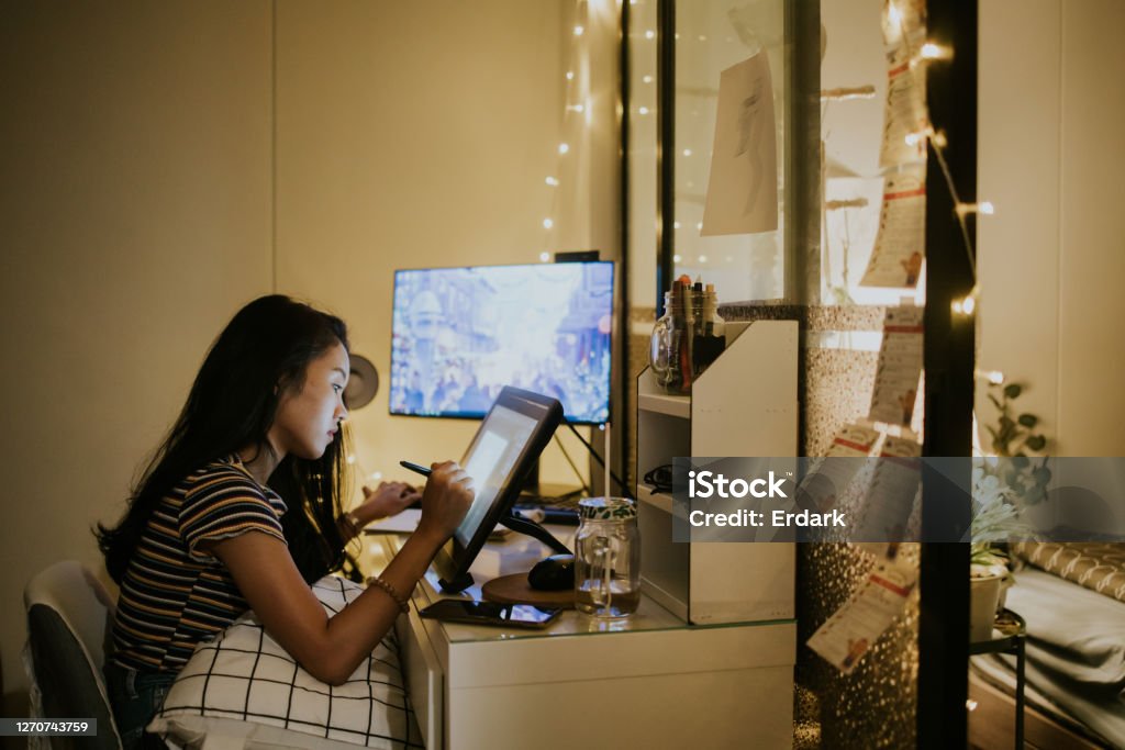 Creative freelancer working is everywhere and everytime-stock photo The concentration of Thai graphic designer and creative animator girl is spending time on her work in the nighttime at home, Bangkok Thailand Animator Stock Photo