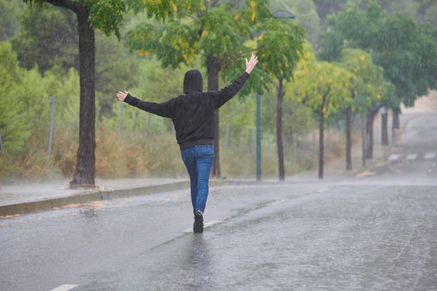 istock woman walking in heavy rain 1270744016