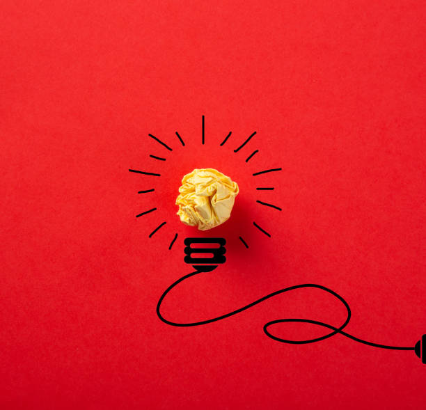 istock Creative idea, Inspiration, New idea and Innovation concept with Crumpled Paper light bulb on red background. 1270744039
