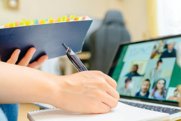 istock Female student joining distant e-learning class via video call on laptop in living room at home 1270746035
