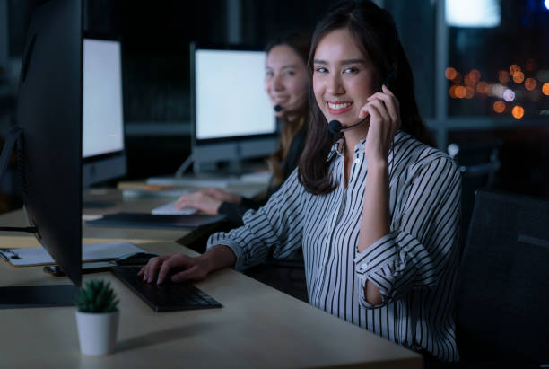 istock Young Thai Asian customer services care operators working night shift in call center for helping assistance client in workplace at night time 1270746863