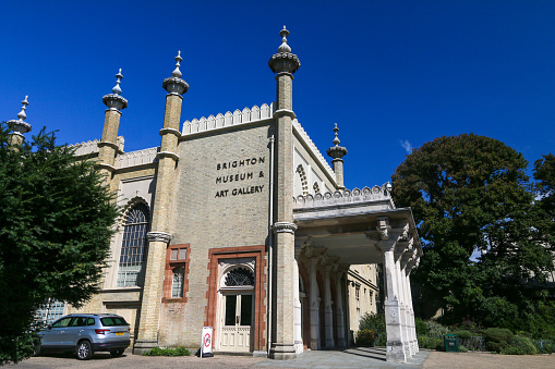 Brighton Museum & Art Gallery in East Sussex, England, with a car and its number plates visible.