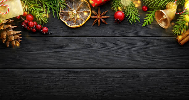 istock Fir tree branches and christmas decorations on black wooden background. Christmas banner, border 1270749672