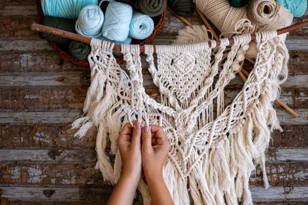 Photo of Weaving macrame at home.