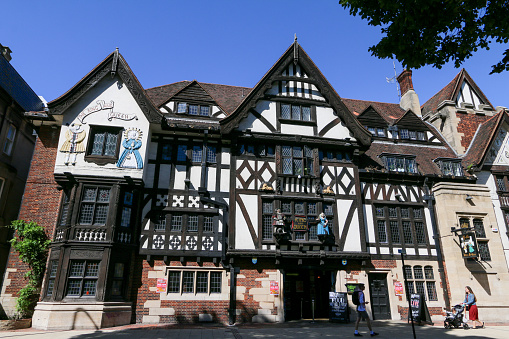 Ye Olde King & Queen in Brighton, England, with people walking past on Marlborough Place. It was built in 1779 as a farmhouse and named in honour of George III and his wife Charlotte.