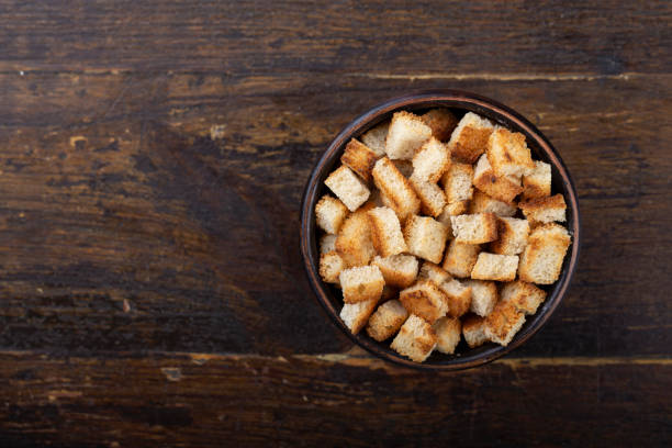 istock Crispy croutons in a bowl on a wooden background. 1270752216