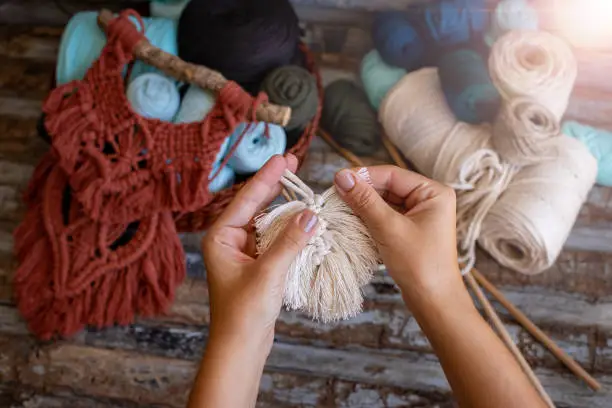 Photo of Weaving macrame at home.