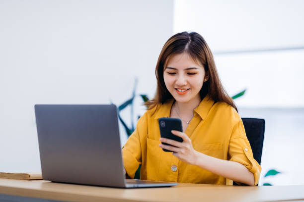 istock Professional Asian businesswoman using a smartphone in office. 1270754034