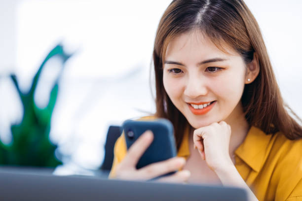 istock Professional Asian businesswoman using a smartphone in office. 1270754041