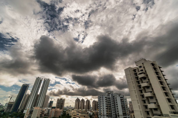 Mumbai, India - June 2020: Wide angle skyline of tall skyscrapers and buildings in suburban Mumbai with dramatic monsoon clouds in the sky.