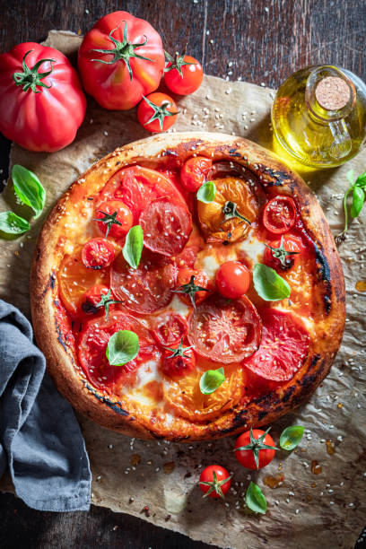 istock Fresh pizza Margherita made of tomatoes, mozzarella and basil 1270755263