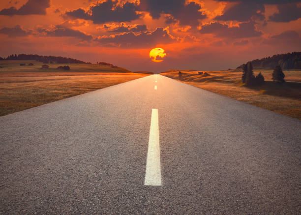 istock Open highway in mountain range towards the sunset 1270755309