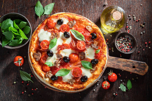 istock Rustic pizza Capricciosa with prosciutto, cheese and mushrooms 1270756303