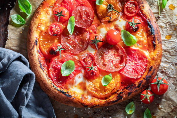 istock Enjoy your pizza Margherita with various tomatoes, basil and mozzarella 1270757065