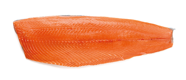 Whole raw salmon fillet isolated on white background. Half of fresh chilled boneless salmon with skin. Design element for healthy eating, seafood recipe ingredient and organic omega 3. Top view.