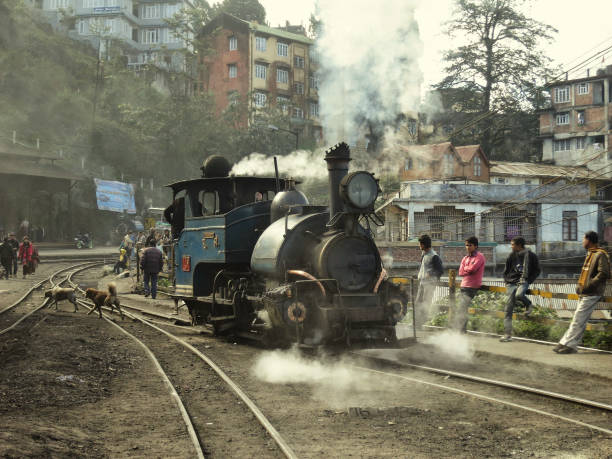 Darjeeling, India - Janurary 2015: A vintage steam engine locomotive running on the rails of the Darjeeling railway station.