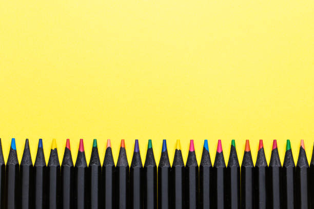 istock Colored pencils in a row on a yellow background 1270758458