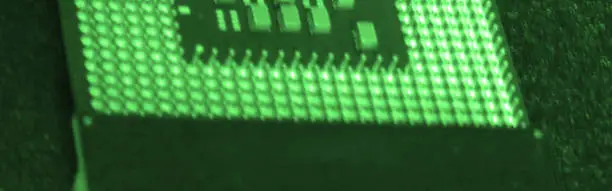 full frame shot of illuminated green CPU lighting equipments on soft surface. items selective focus. Bottom contacts technologies