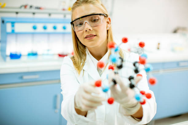 istock Female chemist hold molecular model in the lab 1270759522