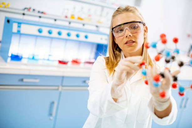 istock Female chemist hold molecular model in the lab 1270759526