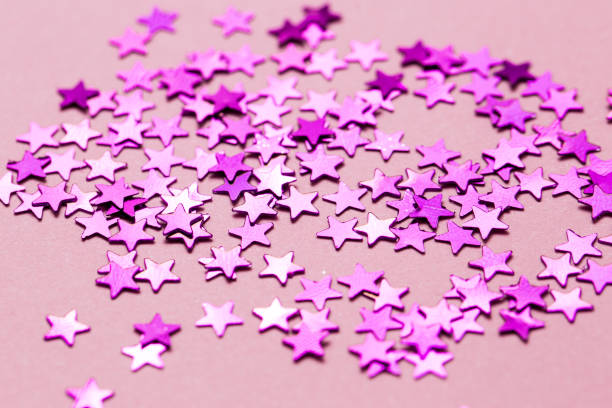 istock Closeup asterisks sprinkled on a pink isolated background. View from above 1270759575