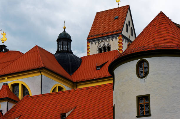 Red roofs of Monastry St. Mang The roofs of St. Mang in Füssen, Bavaria st mang stock pictures, royalty-free photos & images