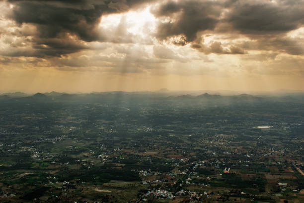 Dramatic landscape of clouds over Yelagiri Hills Dramatic landscape of sunlight streaming through dark monsoon clouds to hit distant hills and the plains in the Yelagiri Hills in Tamil Nadu. tamil nadu landscape stock pictures, royalty-free photos & images