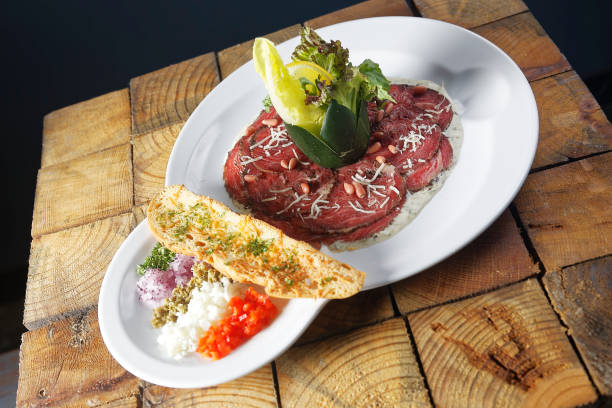 istock Beef carpaccio with toast and lettuce salad. 1270761558