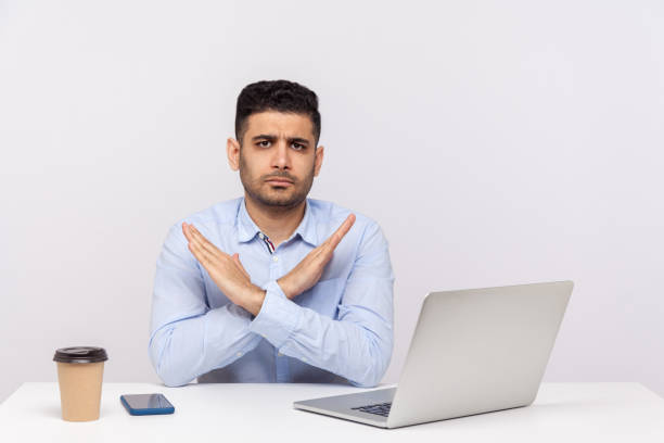 istock This is the end, finish! Strict boss sitting office workplace with laptop on desk, crossing hands showing x sign 1270761922