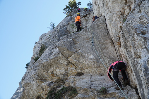 Sivri Dag, Antalya/Turkey-August 30, 2020: Alpinists are climbing the rocky walls of the mountain with rope and security equipments in Antalya